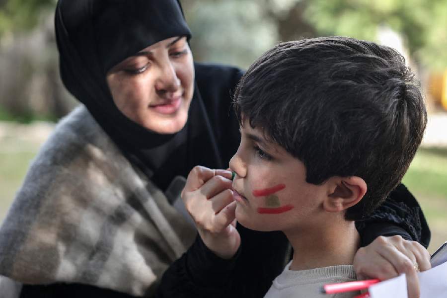 A boy gets face paint taking part in activities organised by Takatafo Campaign and supported by psychologists, to entertain and to mentally support displaced children, in a shelter in Tyre, south Lebanon, April 14, 2026