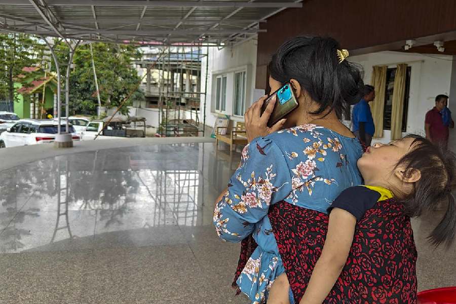 A Meitei community woman with her child arrives from Mizoram at a relief camp.