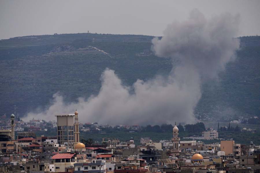 Smoke rises following an Israeli airstrike on the village of Qlaileh, as seen from the southern port city of Tyre, Lebanon, Wednesday, April 15, 2026.