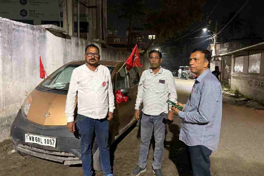 Jibananda Singha (left), the CPM candidate from Raiganj, in front of his Tata Nano car.