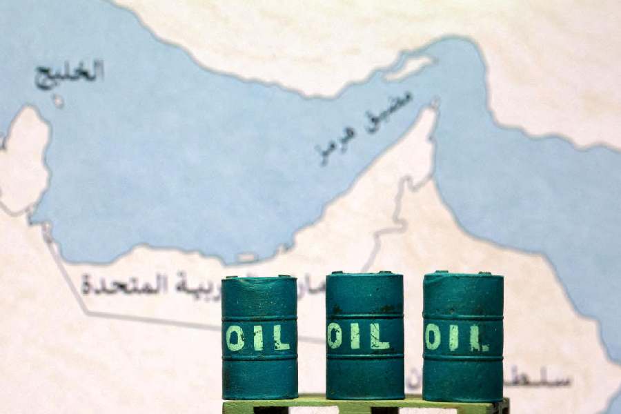 A map showing the Strait of Hormuz, also known as Madiq Hurmuz, and 3D printed oil barrels are seen in this illustration taken March 26, 2026.