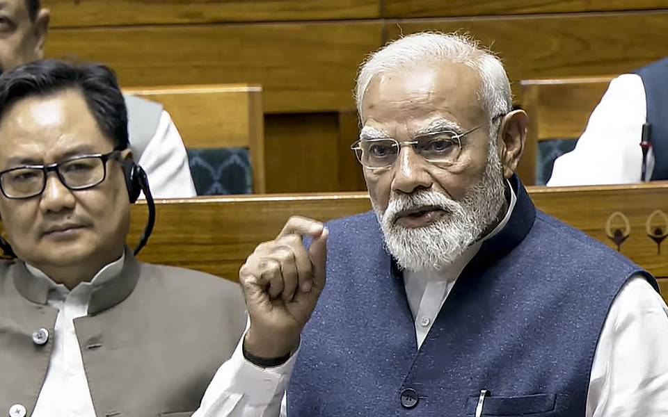 Prime Minister Narendra Modi speaks in the Lok Sabha during the Special session of Parliament, in New Delhi, Thursday, April 16, 2026. Union Minister Kiren Rijiju is also seen.