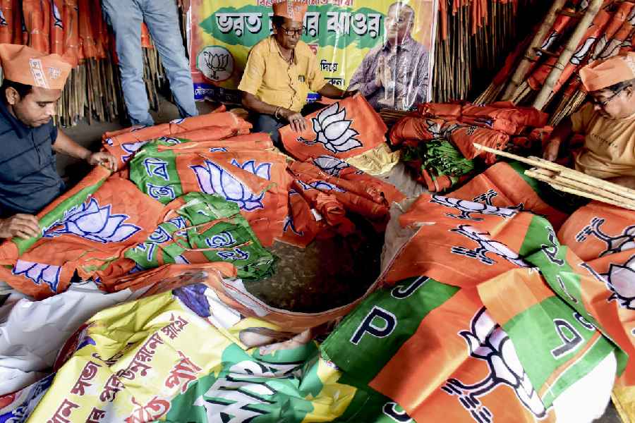 BJP workers arrange party flags ahead of the campaigns for Beldanga Assembly constituency ahead of the state Assembly elections, in Beldanga, West Bengal, Sunday, March 29, 2026.