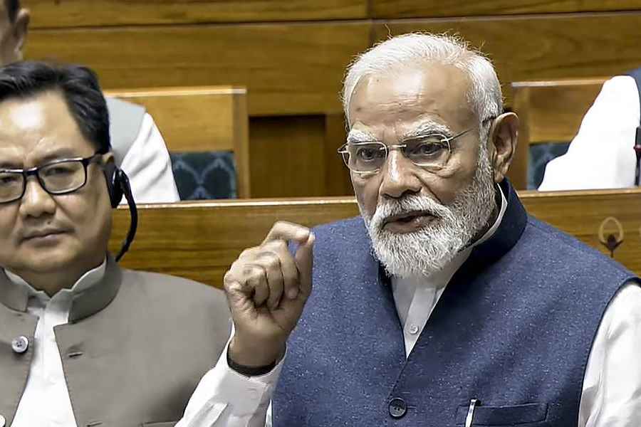 Prime Minister Narendra Modi speaks in the Lok Sabha during the Special session of Parliament, in New Delhi, Thursday, April 16, 2026. Union Minister Kiren Rijiju is also seen.