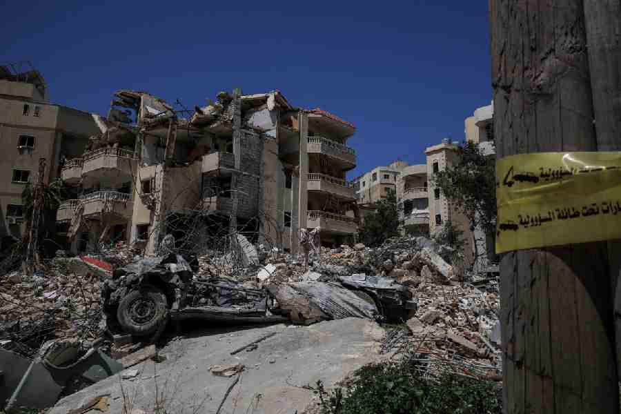 A damaged building, rubble and a destroyed vehicle in the aftermath of Israeli strikes, near Hiram Hospital in Tyre, south Lebanon, April 16, 2026.