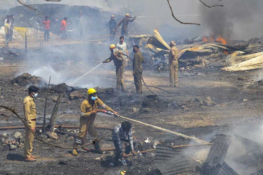 Firefighters conduct a dousing operation after a massive fire broke out in the Kanawani slum area of Indirapuram, engulfing several houses, in Ghaziabad district, Uttar Pradesh, Thursday, April 16, 2026.