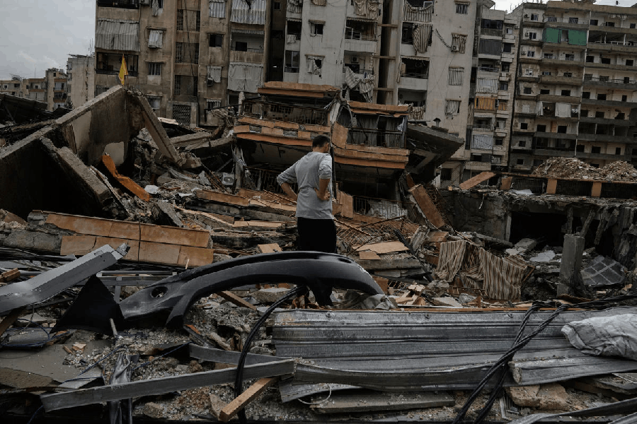 A man inspects the damage of a destroyed building in Dahiyeh, Beirut's southern suburbs, Lebanon, Friday, April 17, 2026, following a ceasefire between Israel and Hezbollah.