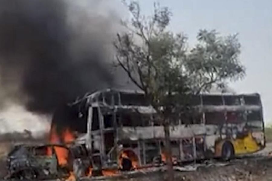 Flames and smoke billow from a bus after a car allegedly collides head-on with it, in Yadgir, Karnataka, Friday, April 17, 2026.