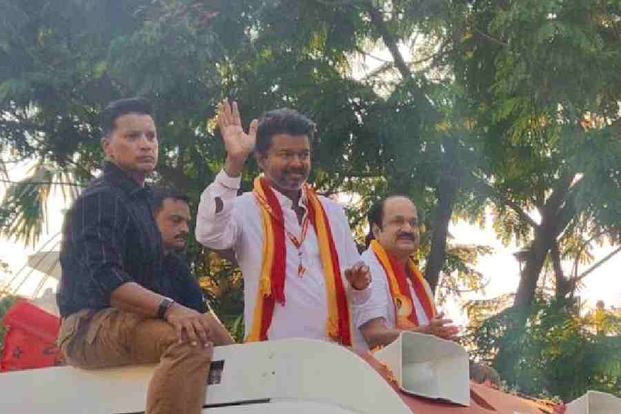Vijay waves to fans at a TVK roadshow at Valluvar Kottam in Chennai on April 15.