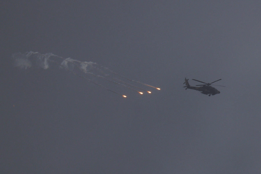An Israeli helicopter releases flares over Lebanon, after a 10-day ceasefire between Lebanon and Israel went into effect, as seen from Israel, April 17, 2026.