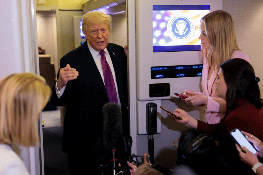 U.S. President Donald Trump talks to members of the media aboard Air Force One en route to Joint Base Andrews, Maryland, U.S., April 17, 2026.