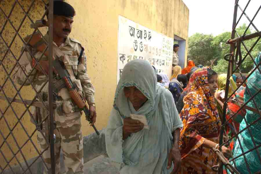 A woman enters a polling booth