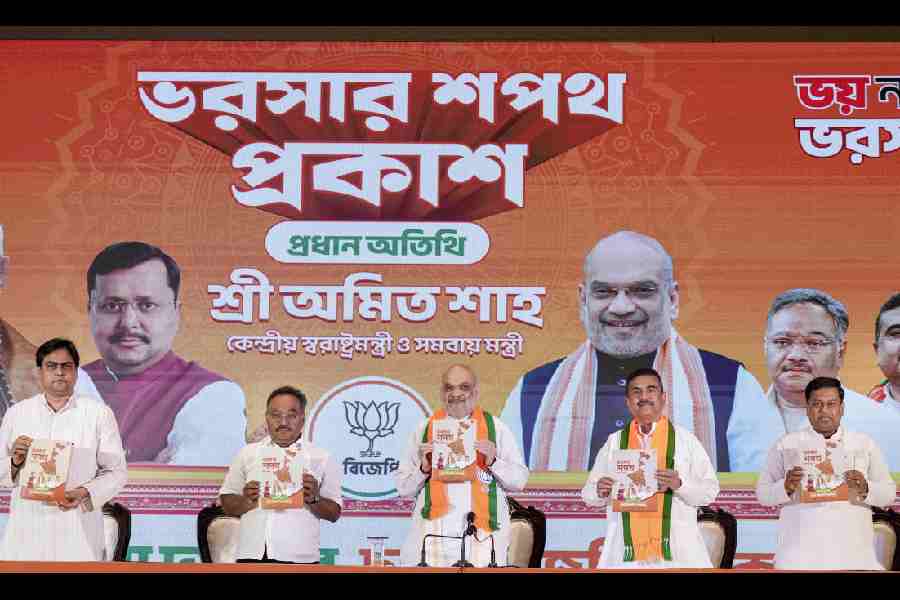 Union Home Minister Amit Shah, centre, Union Minister Sukanta Majumdar, right, Leader of Opposition in the West Bengal Assembly Suvendu Adhikari, second right, state BJP President Samik Bhattacharya, second left, and others during the unveiling of 'BJP Sankalp Patra', the party's manifesto for the upcoming state Assembly elections, in Kolkata, Friday, April 10, 2026.