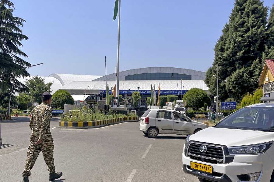 A security personnel patrols inside the Srinagar airport after flight services were fully restored, in Srinagar, Tuesday, May 20, 2025.