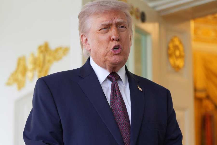A displaced resident looks out at destruction caused by Israeli strikes as she drives home following a 10-day ceasefire between Lebanon and Israel that went into effect, in Nabatieh, Lebanon, April 18, 2026.