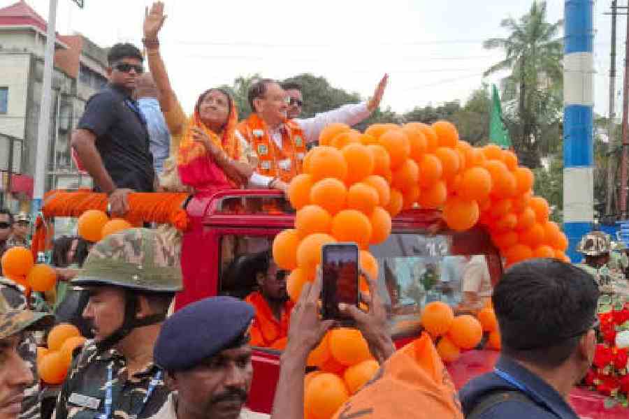 Union minister J.P. Nadda at a road show in support of Dabgram-Fulbari BJP candidate Sikha Chatterjee (left) near Siliguri town on Sunday. Picture by Passang Yolmo