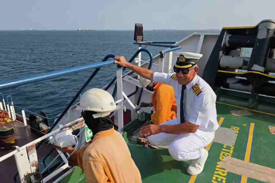 In this picture courtesy of Captain Rahman Al-Jubouri, he, right, supervises sailors on the deck of the Sea Moon oil tanker on the waters the Gulf of Oman, Wednesday, April 15, 2026.