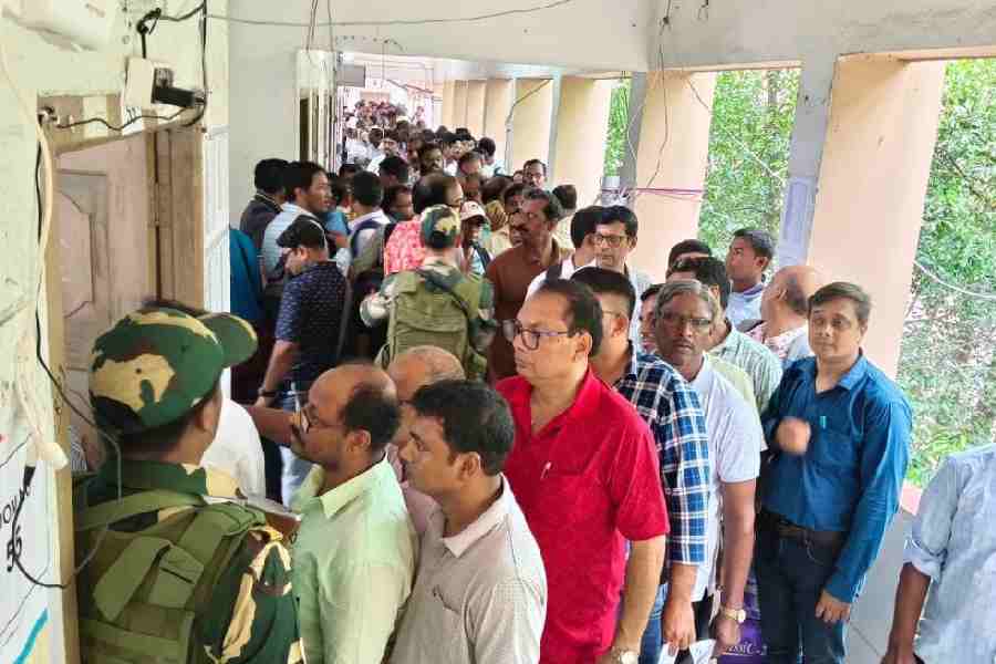 A central force jawan stands guard as polling staff cast their votes in Burdwan on Monday.