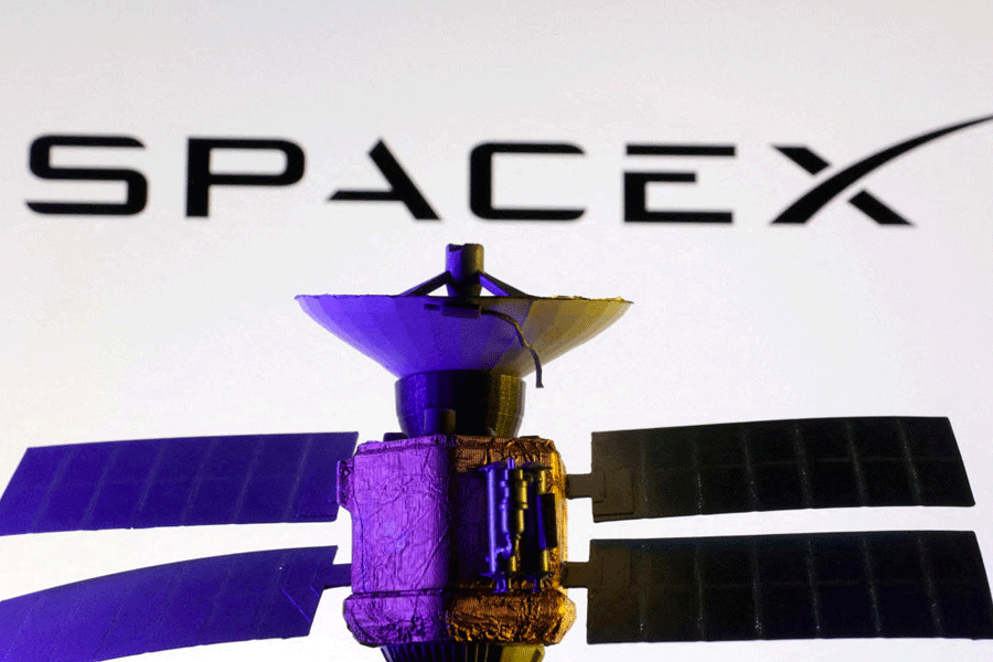 FILE PHOTO: SpaceX logo and miniature satellite model are seen in this illustration taken, March 10, 2025.