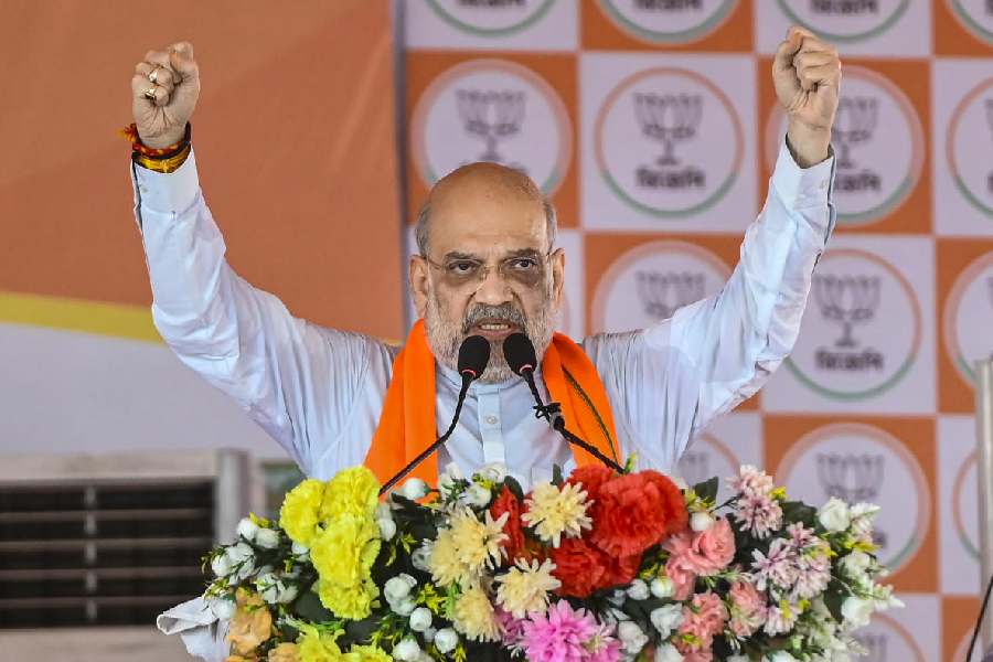 Union Home Minister Amit Shah addresses a public meeting in support of BJP candidates ahead of the West Bengal Assembly elections, in Dakshin Dinajpur, Tuesday, April 14, 2026.
