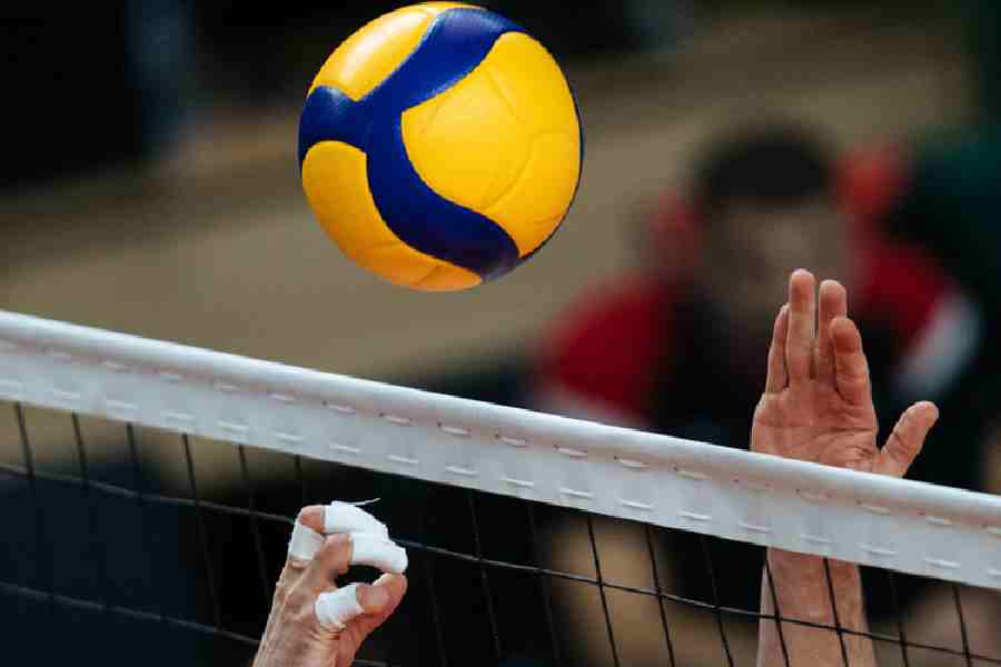 Volleyball being played over a net