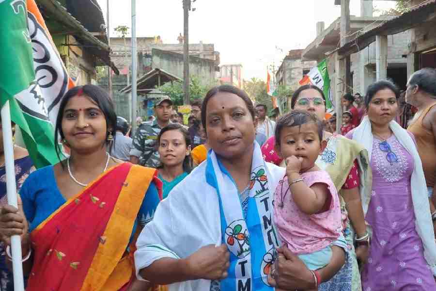 Birbaha Hansda (cradling a child) canvasses for votes at a village in Binpur