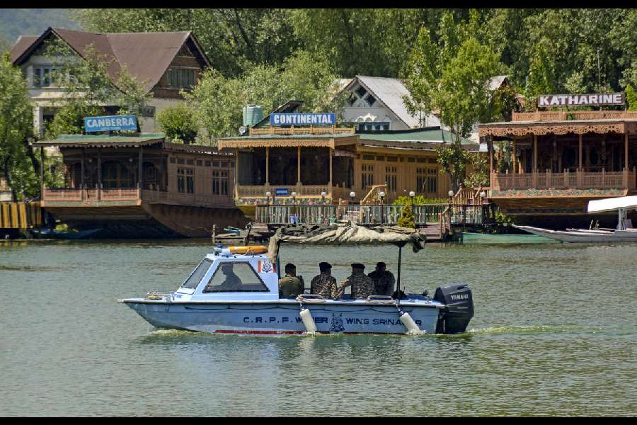 Security personnel patrol Dal Lake on a boat amid heightened alert ahead of the first anniversary of the Pahalgam attack