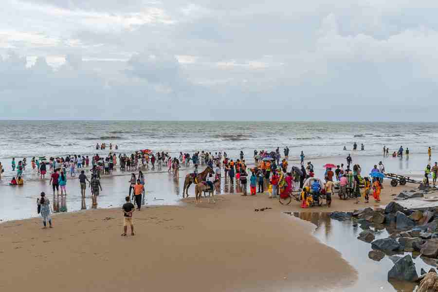 Tourists on the beach at Mandarmani. 