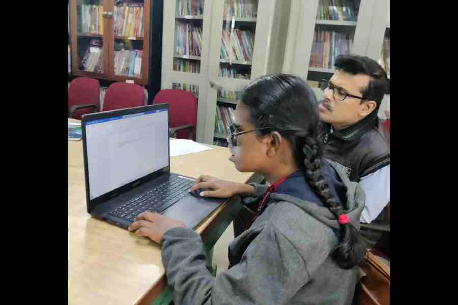 Jitnita Toppo types on a laptop