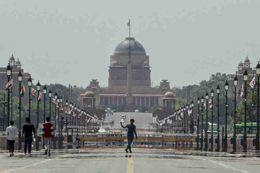 People take a walk at Kartavya Path on a hot summer day, in New Delhi, Monday, April 20, 2026.