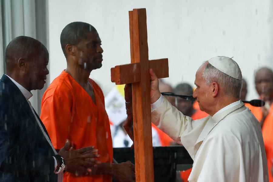 Pope Leo XIV receives a cross from an inmate during the pope's visit at the Bata prison in Bata, Equatorial Guinea, April 22, 2026