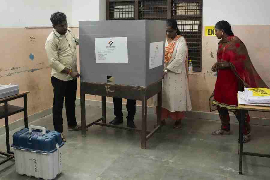 Poll officials make arrangements at a polling station