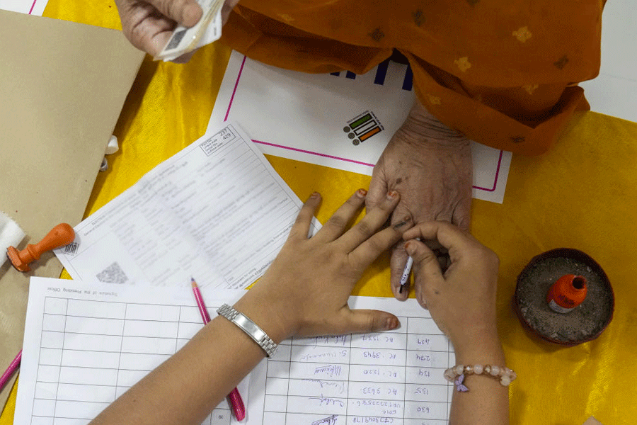 A polling official marks a voter's finger with indelible ink during voting in the Tamil Nadu Assembly elections, at a polling station in Chennai, Thursday, April 23, 2026.