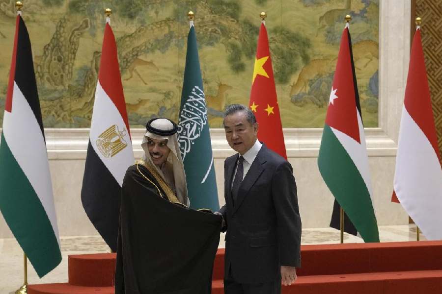 Chinese Foreign Minister Wang Yi, right, shakes hands with Saudi Arabia's Foreign Minister Faisal bin Farhan Al Saud as he welcome five Arab and Islamic counterparts at the Diaoyutai state guesthouse in Beijing, Monday, Nov. 20, 2023.