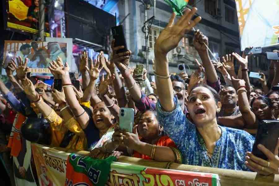 Women cheer as Narendra Modi passes by during a road show in Howrah on Thursday night
