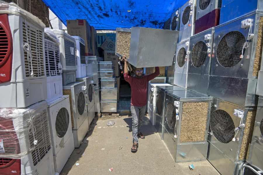 A vendor arranges a cooler for the summer season on a hot day, in Prayagraj, Uttar Pradesh, Monday, April 13, 2026.