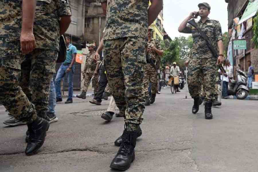 Central force personnel on a route march in Kidderpore last week. (Sanat Kr Sinha)