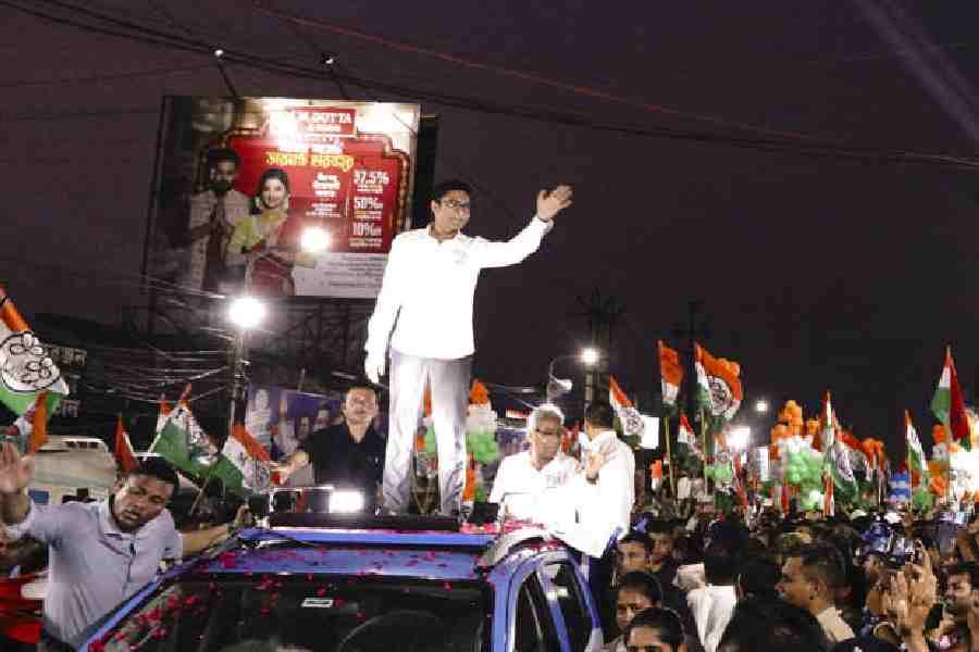 Abhishek Banerjee, atop a car, greets supporters during a road show in Diamond Harbour, South 24-Parganas, on Friday.