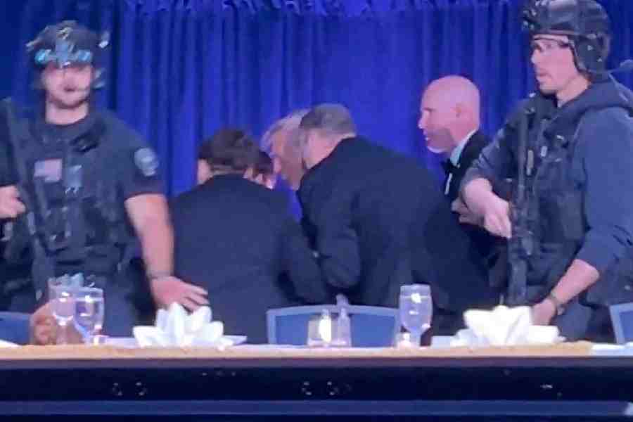 U.S. President Donald Trump is escorted out as a shooter opens fire during the annual White House Correspondents' Association dinner in Washington, D.C., U.S., April 25, 2026, in this screen capture from video.