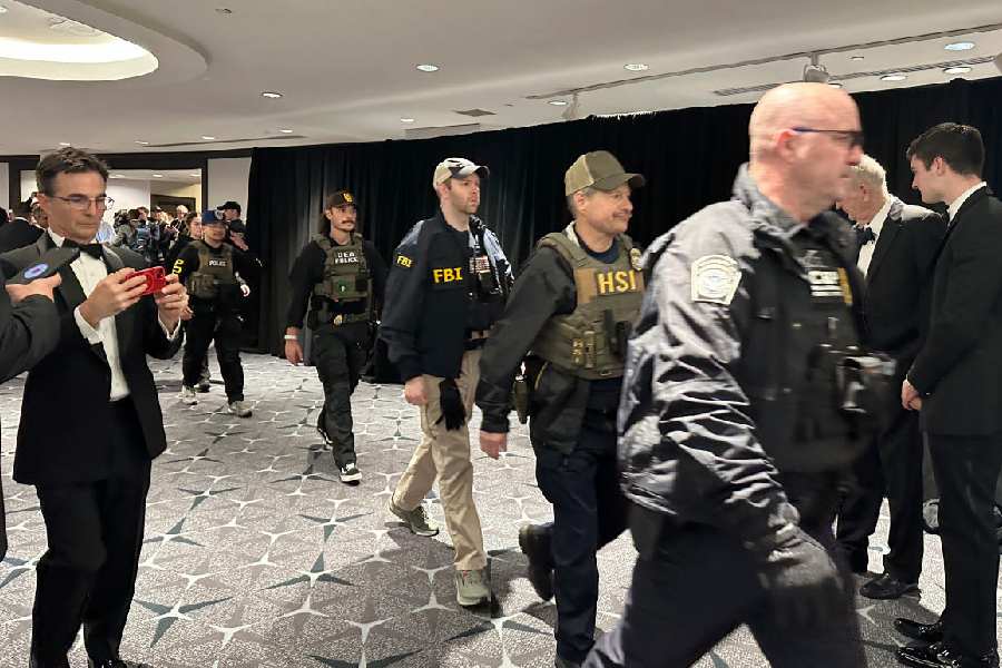 Members of law enforcement respond during the White House Correspondents Dinner, Saturday, April 25, 2026, in Washington.