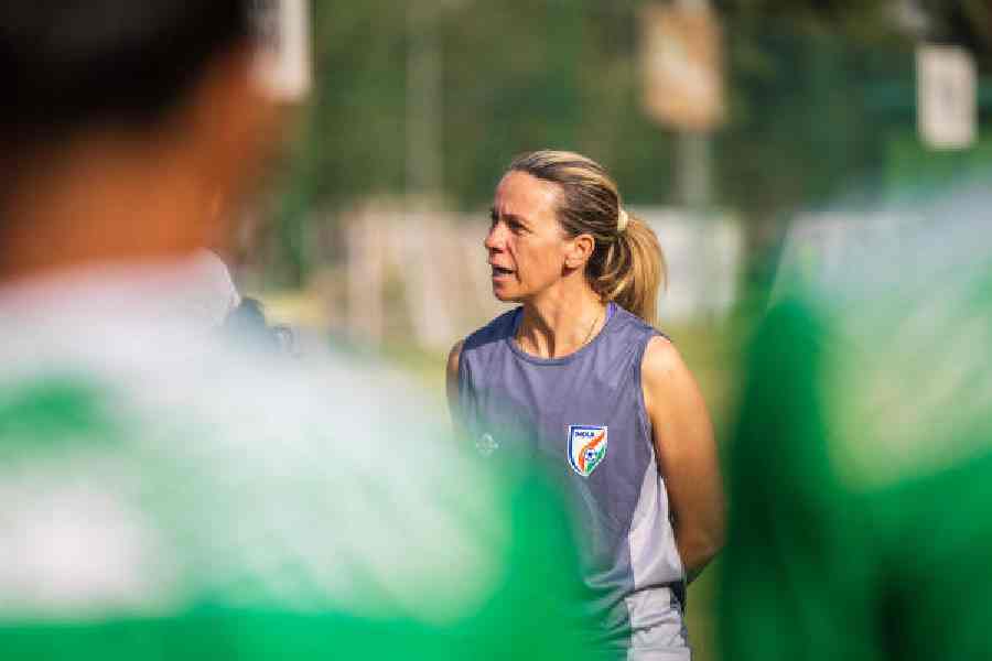 Pamela Conti, India women’s Under-17 football team coach, speaks to her wards ahead of a training session.