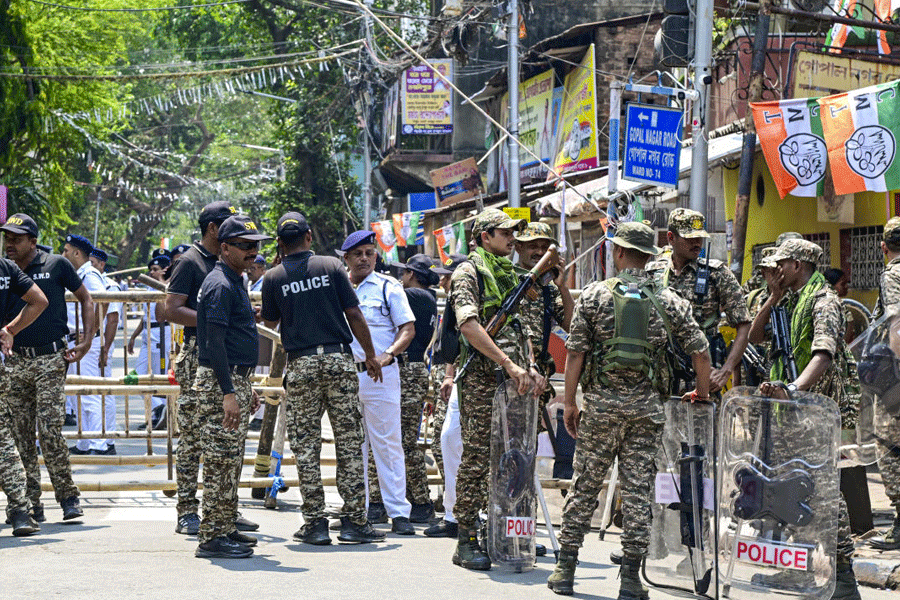 Security personnel stand guard at the Survey Building during nomination filing for the West Bengal Assembly elections, in Kolkata, Monday, April 6, 2026.