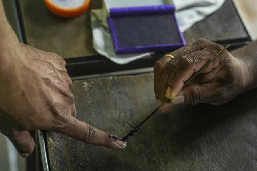 A voter casts vote during the first phase of the West Bengal Assembly election, in Nandigram, Purba Medinipur district, Thursday, April 23, 2026.