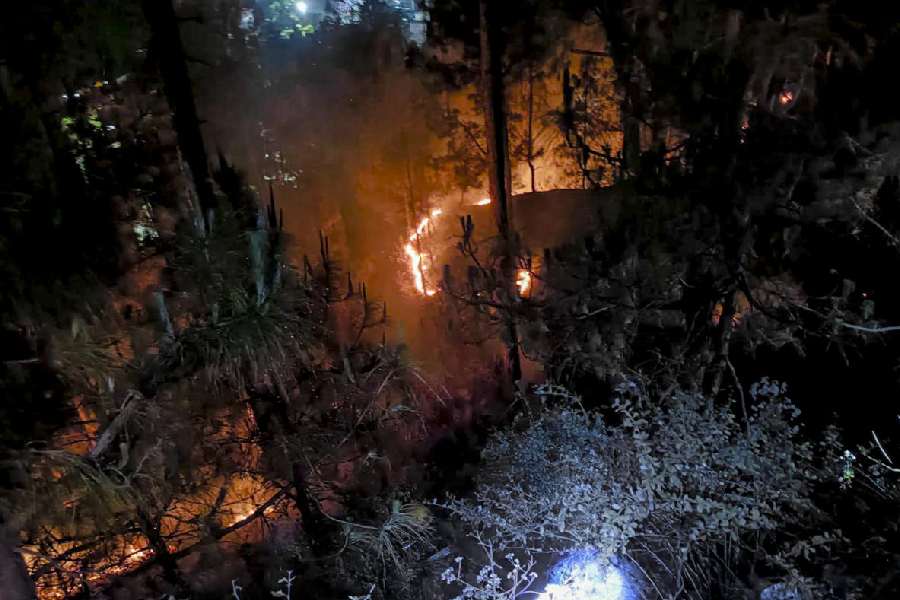 Smoke and flames billow during a forest fire at Ranikhet, in Almora district, Uttarakhand, late Friday, April 24, 2026.