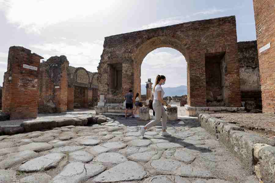 Tourists visit the archaeological site of the ancient Roman city of Pompeii