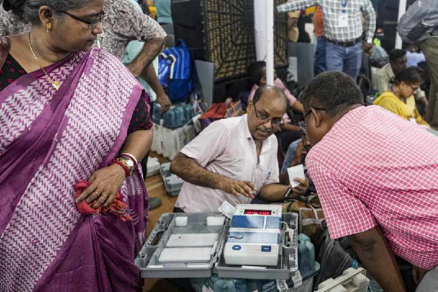 Polling officials check election materials for voting in the second phase of the West Bengal Assembly elections, at a distribution centre in Kolkata, Tuesday, April 28, 2026.