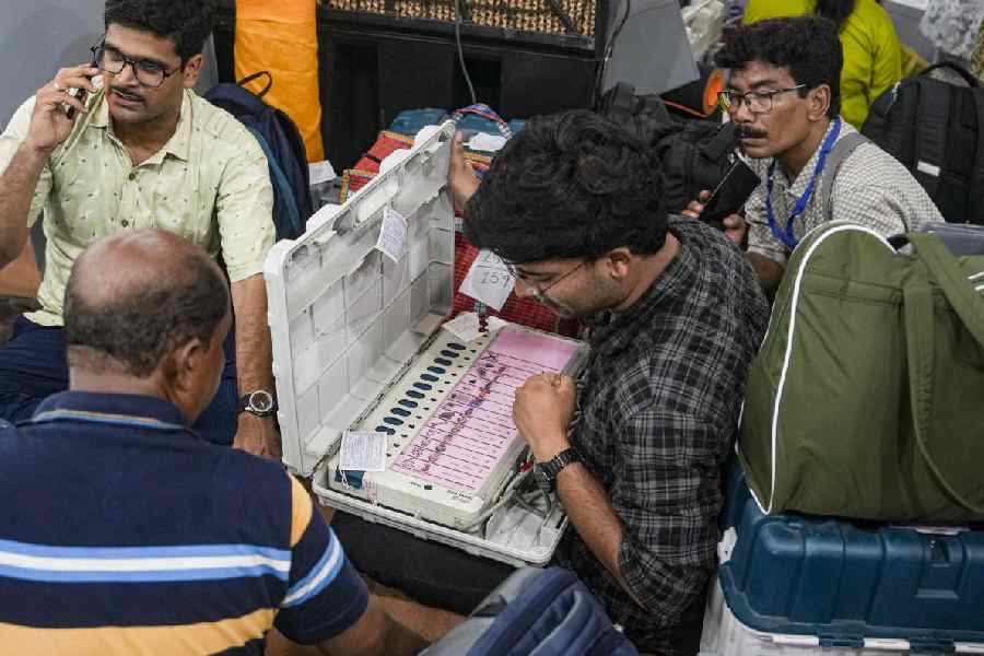 Polling officials check election materials for voting in the second phase of the West Bengal Assembly elections, at a distribution centre in Kolkata, Tuesday, April 28, 2026.