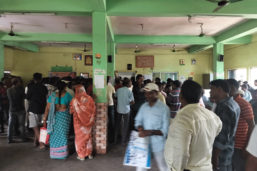People standing in the hall at Arjun Singh's house at North 24 Pargana