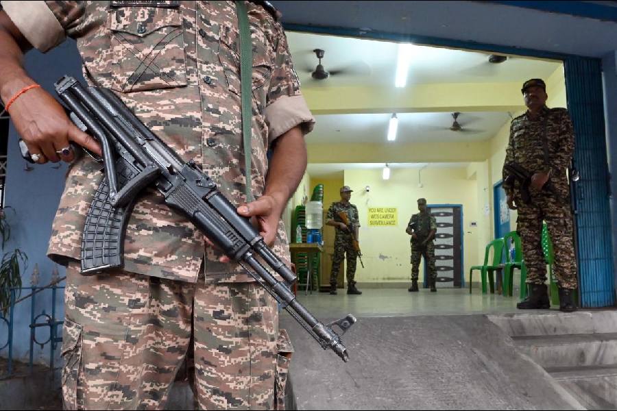 A gun-toting central force jawan guards a polling booth in Bhabanipur on Tuesday. 