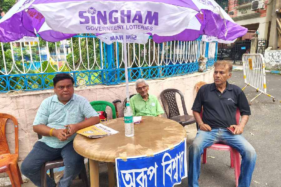 Arindam Ganguly (left) and other TMC workers at their booth camp in Ward 98